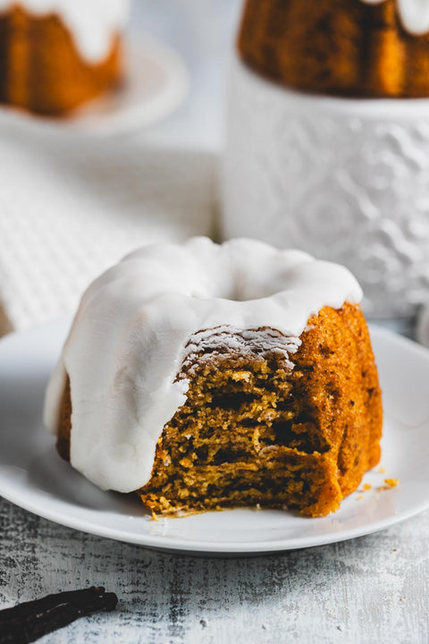 mini lemon pound bundt cake with a bite out of it on a plate