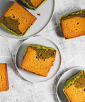 lemon matcha loaf with matcha glaze, with slices taken out on plates