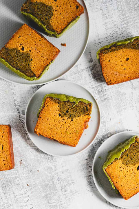 lemon matcha loaf with matcha glaze, with slices taken out on plates
