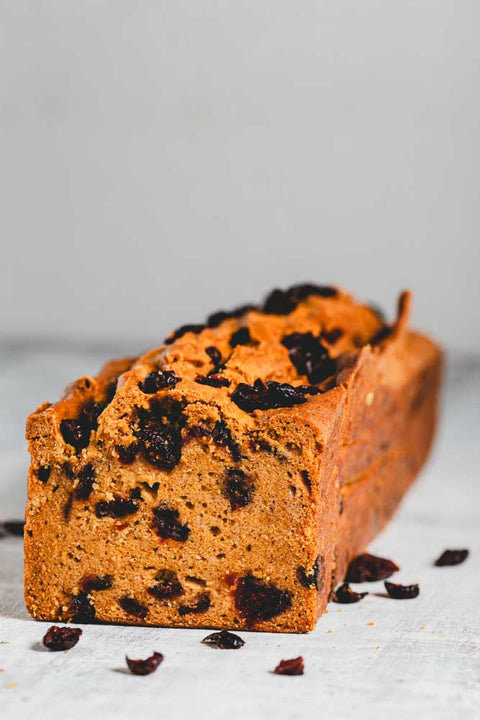 pumpkin loaf with cranberries in it and sprinkled around