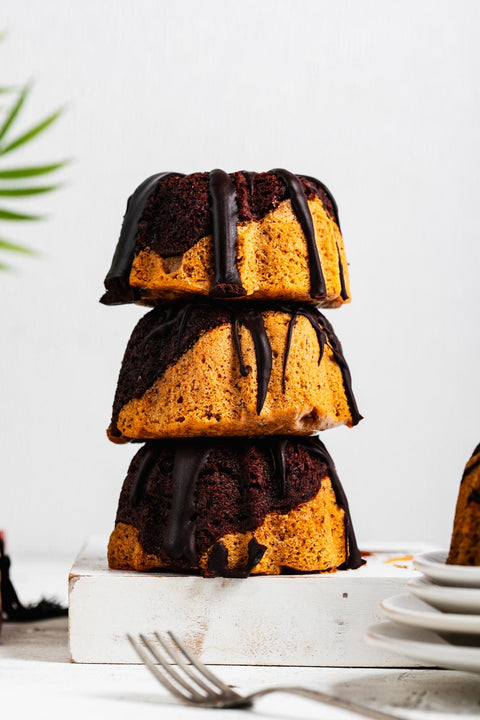 a stack of mini marble bundt cakes with chocolate glaze