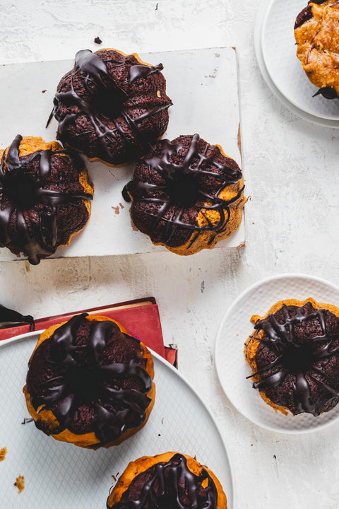 mini marble bundt cakes with chocolate glaze on various plates