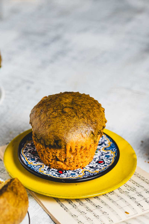 A Lemon Matcha Muffin on a blue and white patterned plate