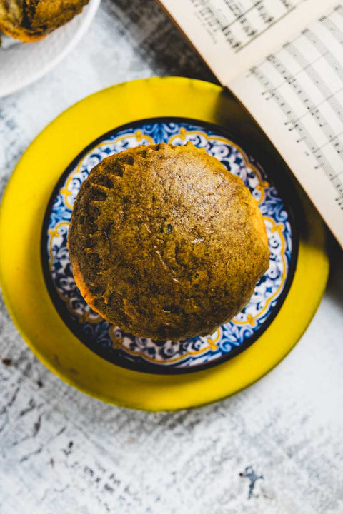 A Lemon Matcha Muffin on a blue and white patterned plate
