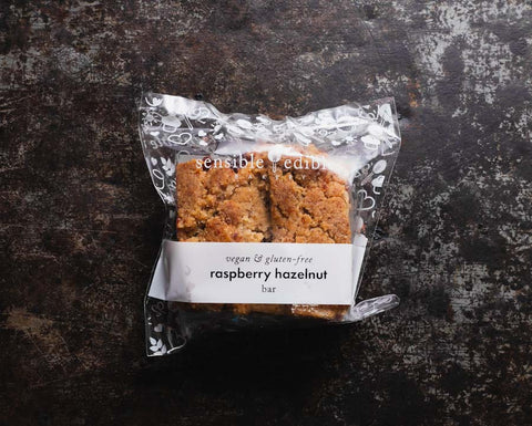 Vegan Gluten-free Raspberry Hazelnut Bar Packaged on Black Background
