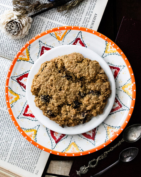 Vegan & Gluten-Free Oatmeal Raisin Cookie on White and Orange Plate