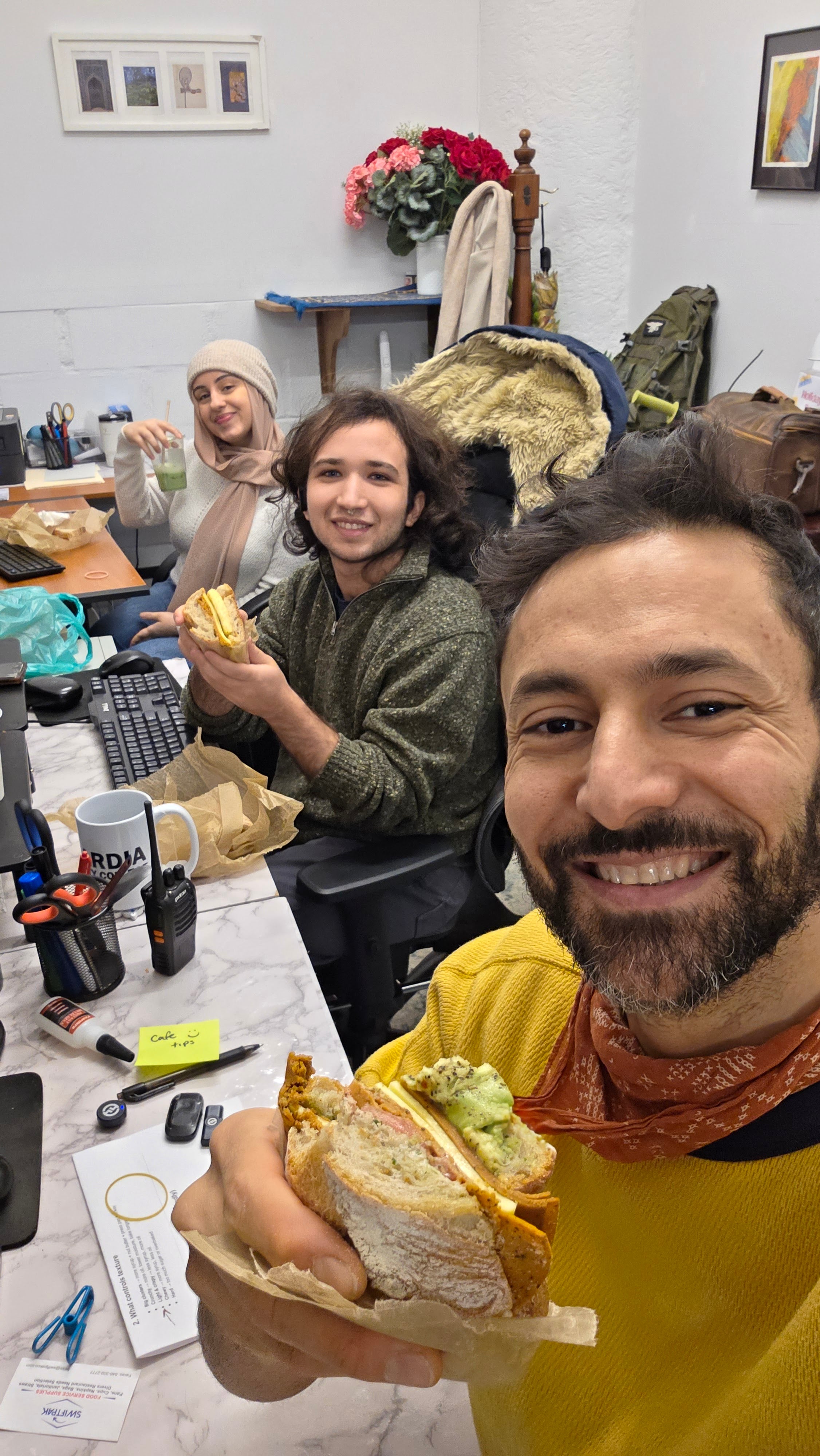 three people eating vegan sandwiches