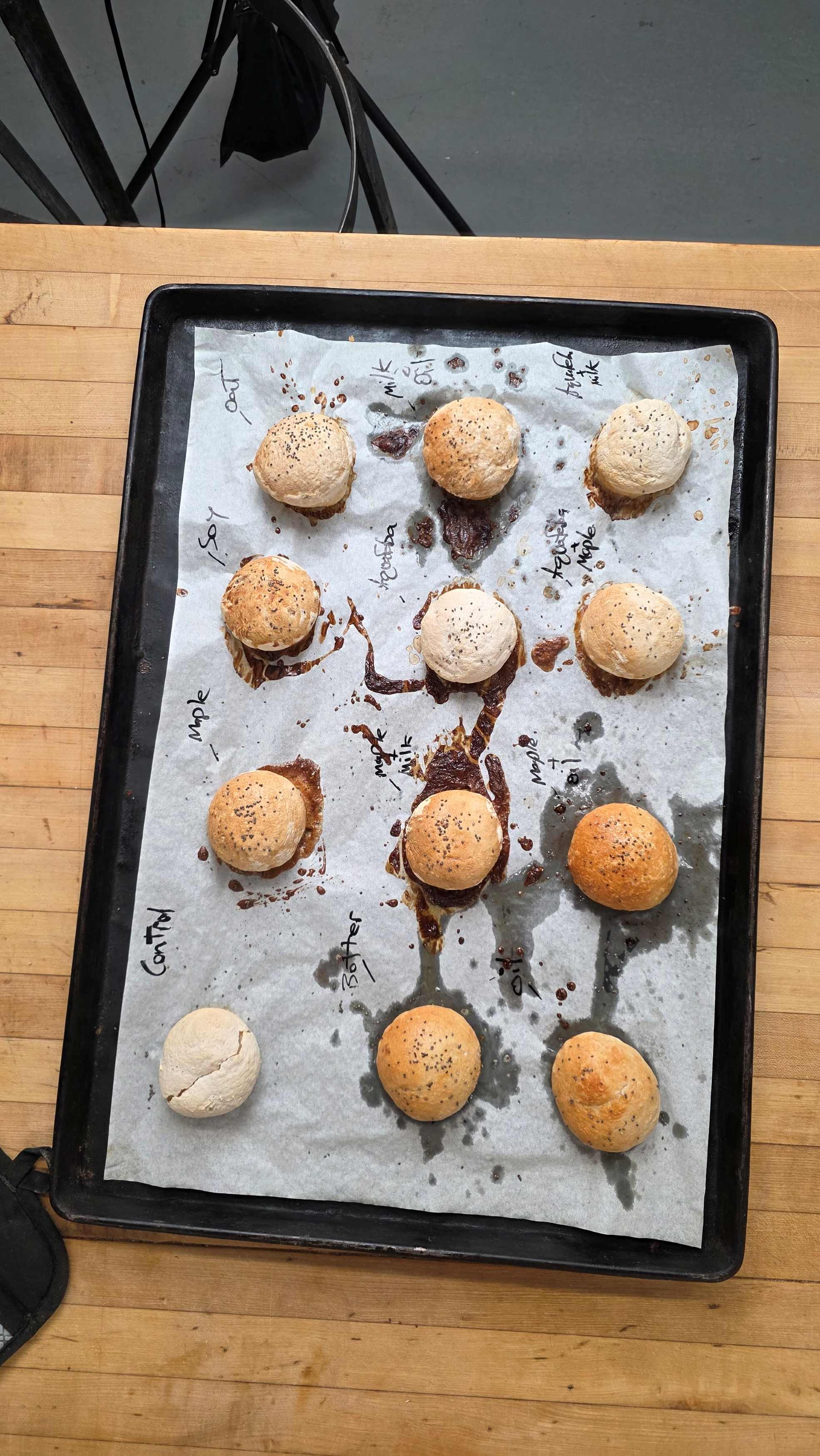A tray of vegan gluten free rolls testing different egg wash alternatives.