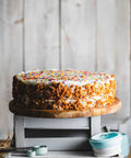 Vegan & Gluten-Free Vanilla Birthday Cake with Sprinkles on a Cake Stand