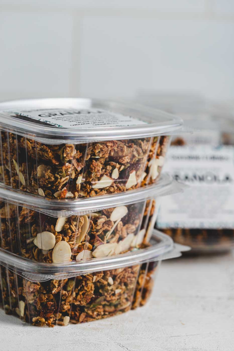 Stack of boxes of granola with oats, pumpkin seeds, almonds, and cranberries