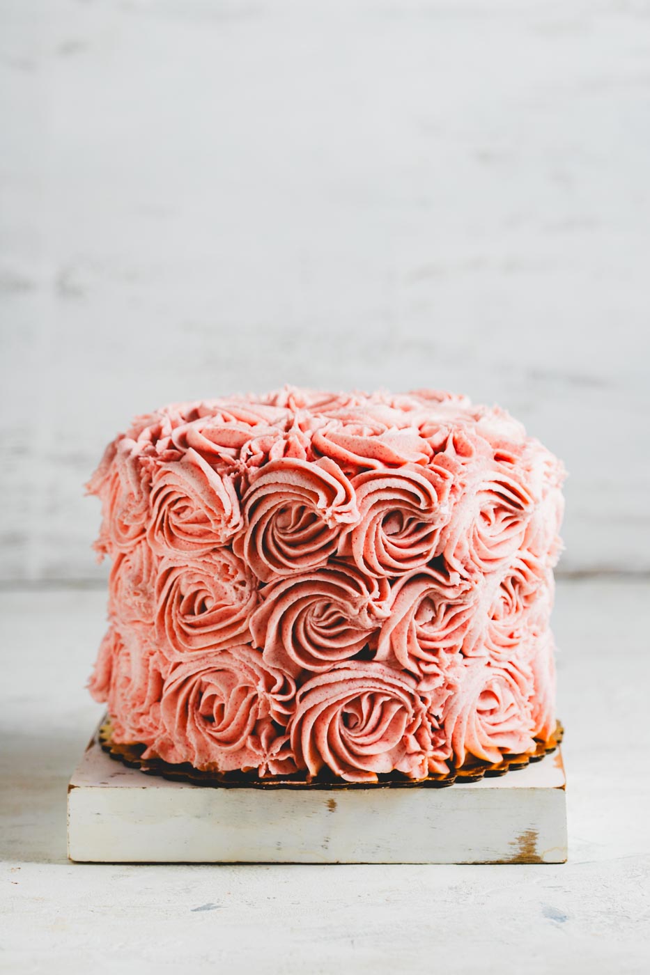 chocolate cake with pink frosting in a flower design 
