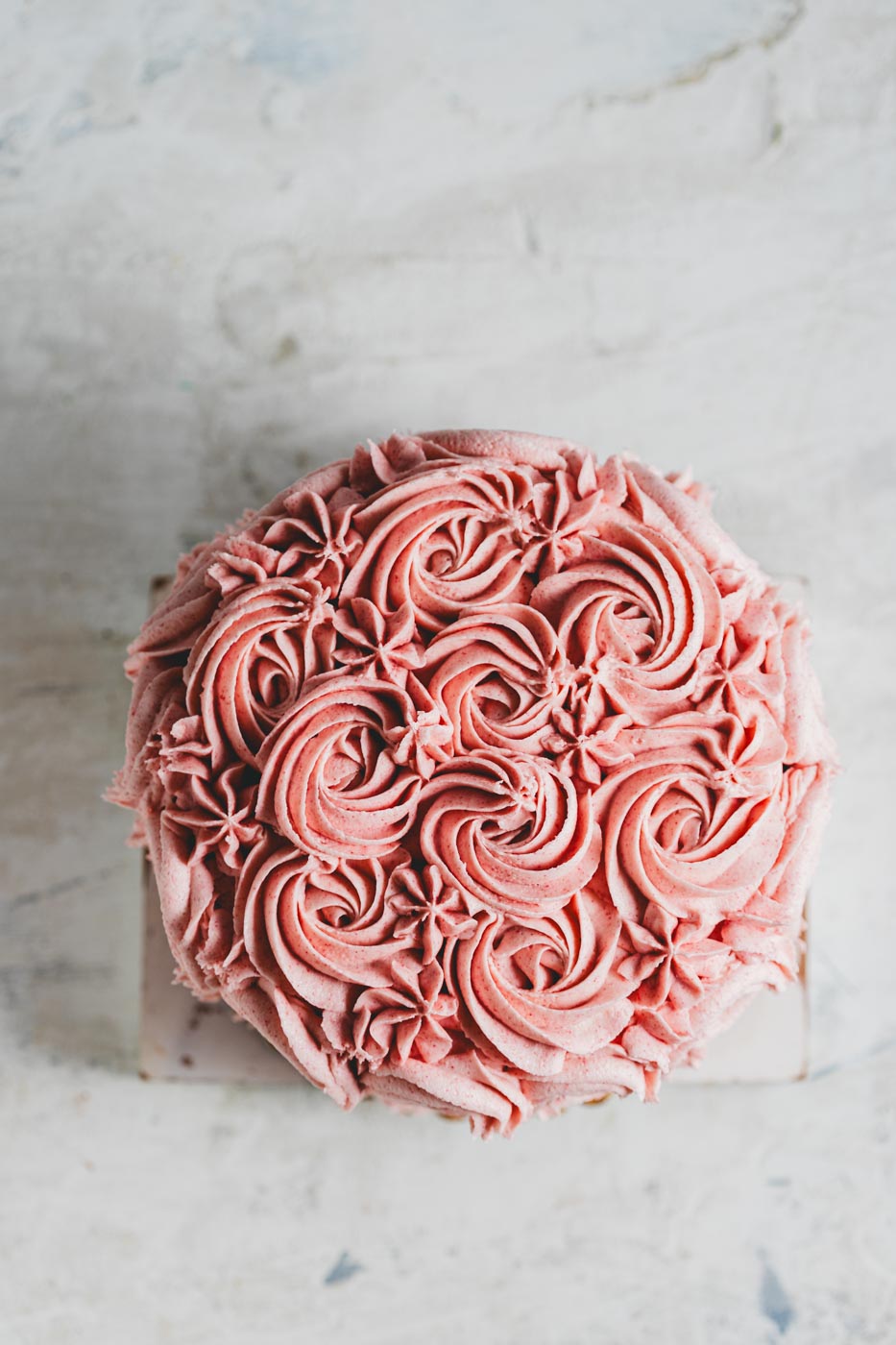 chocolate cake with pink frosting in a flower design 