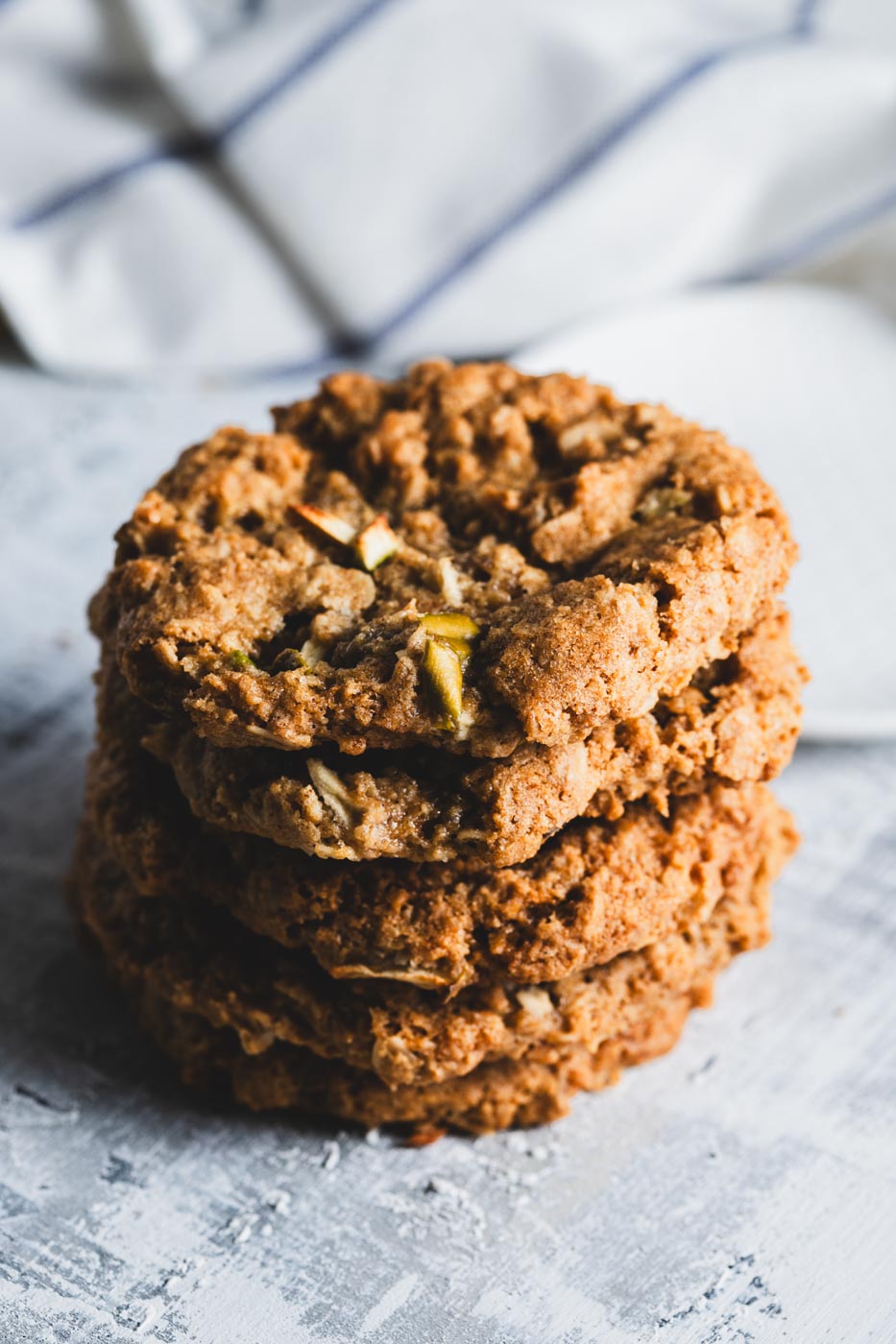 A stack of apple oatmeal cookies on a light background
