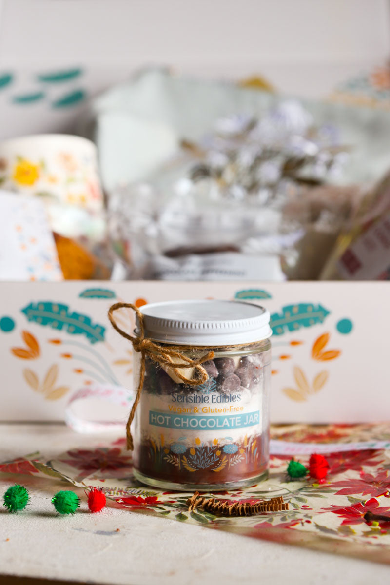 Jar of hot chocolate mix on a patterned surface