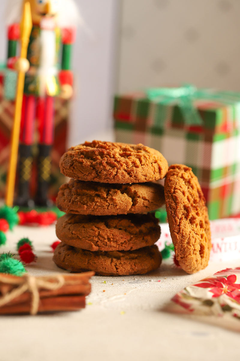 Stack of ginger spice cookies with a festive background