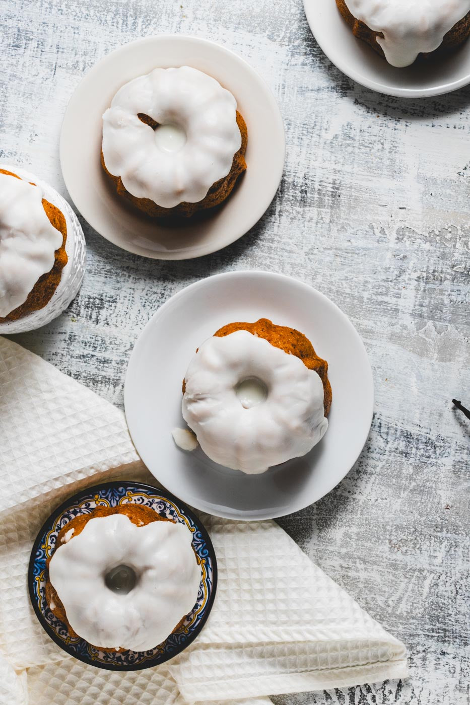 mini lemon pound bundt cakes with glaze on plates