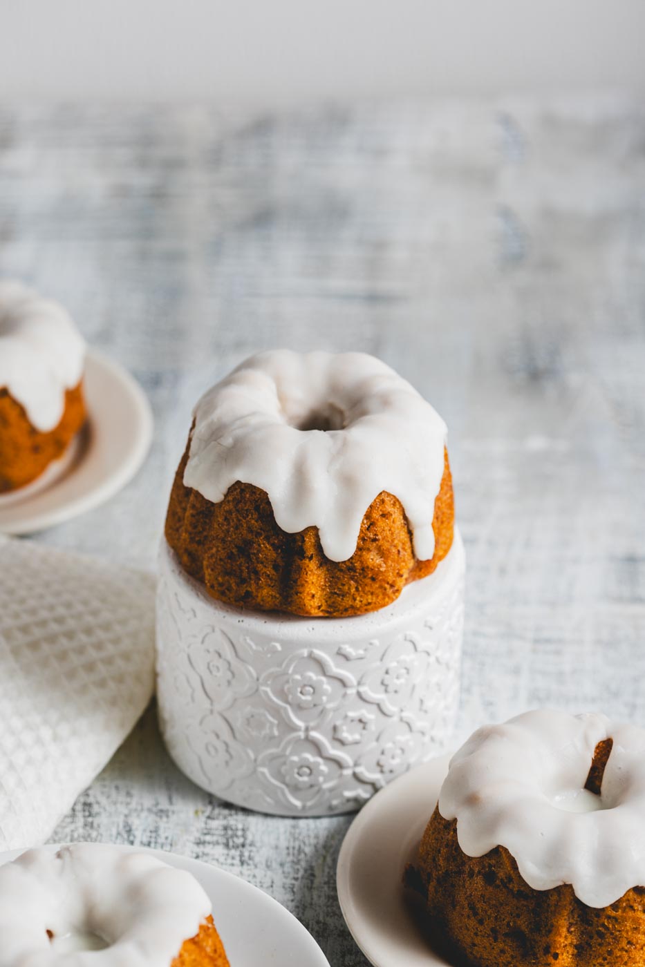 mini lemon pound bundt cakes with glaze on plates