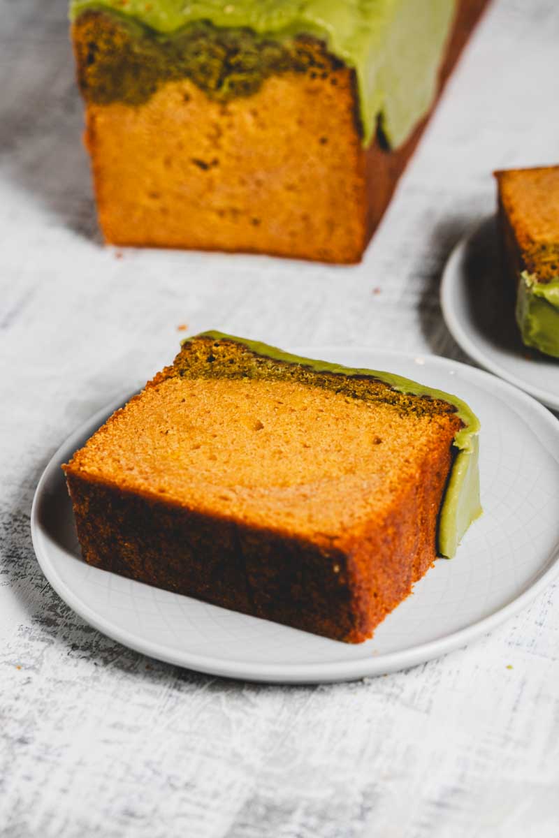 lemon matcha loaf with matcha glaze, with slices taken out on plates