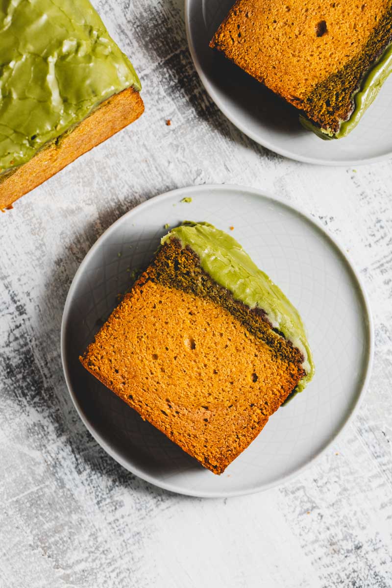 lemon matcha loaf with matcha glaze, with slices taken out on plates