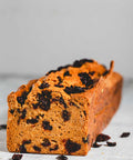 pumpkin loaf with cranberries in it and sprinkled around