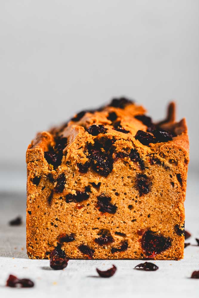 pumpkin loaf with cranberries in it and sprinkled around
