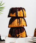 a stack of mini marble bundt cakes with chocolate glaze