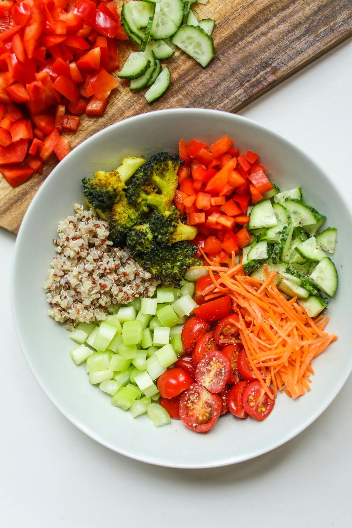 A bowl of a variety of different vegetables and couscous