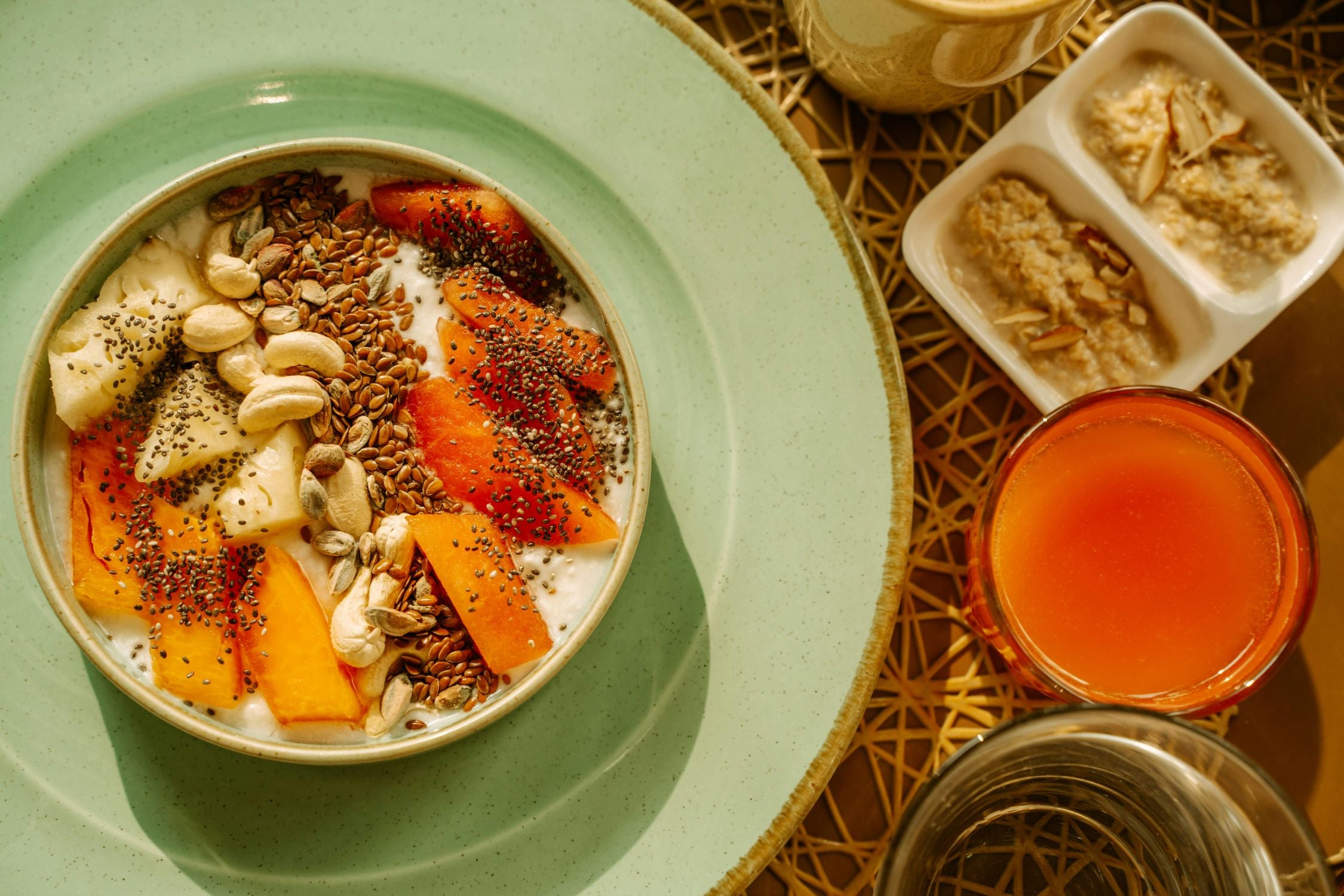 a healthy yogurt bowl with fruits, nuts, and seeds