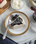 Vegan & Gluten-Free Cheesecake Slice with Blueberry Jam Spread on White Plate