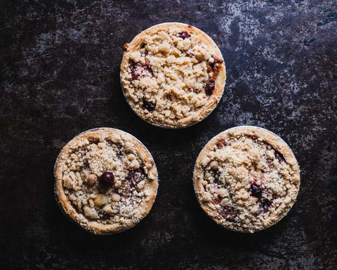 Vegan Gluten-free Mini Cranberry Apple Pie on black background