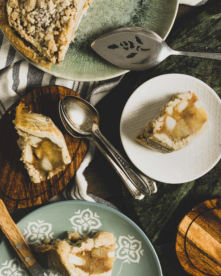 Mini apple crumb slices on various plates with metal spoons