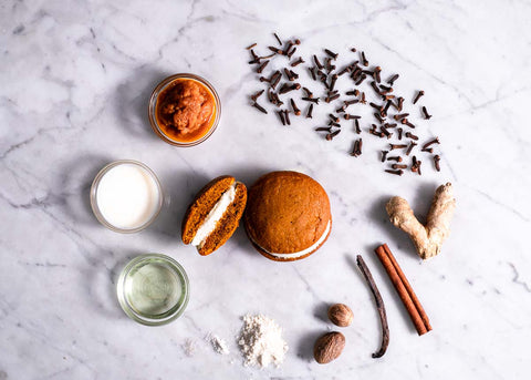 Ingredients for pumpkin spice whoopie pies: apple puree, cloves, ginger, nutmeg, cinnamon, flour, vanilla, vegetable oil, milk, and a whoopie pie.