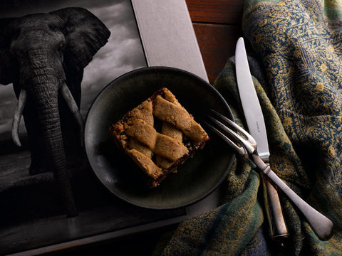 Vegan & Gluten-Free Raspberry Hazelnut Bar on Black Plate with Fork and Knife