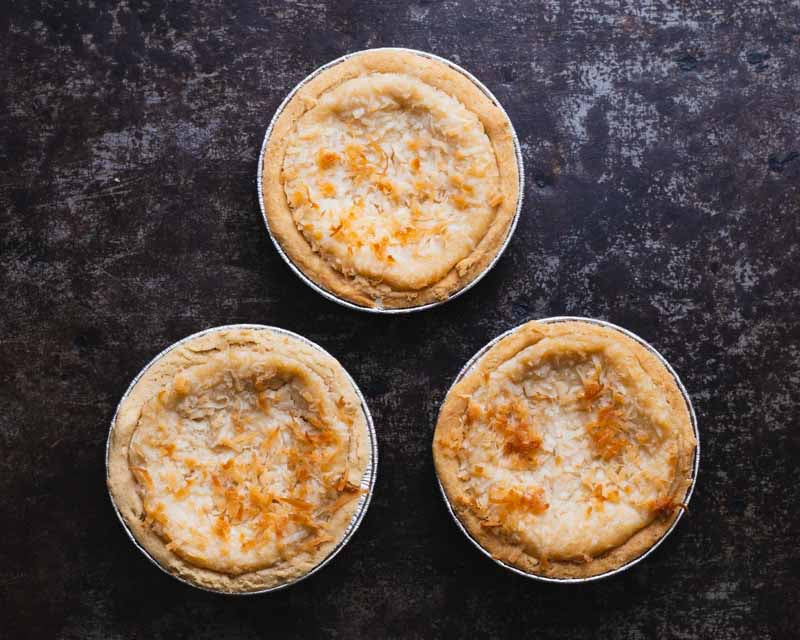 3 Vegan & Gluten-Free Mini Coconut Custard Pies on Black Background