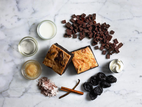 Vegan & Gluten-Free Cheesecake Brownie with Ingredients on Marble